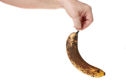 Hand holds a ripe banana on a white background, template for designers. Close up