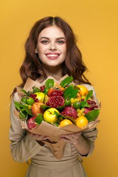 pretty woman smile posing fresh fruits bouquet emotions isolated background. High quality photo