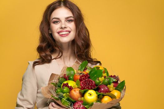 pretty woman smile posing fresh fruits bouquet emotions isolated background. High quality photo