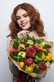beautiful woman fashionable hairstyle bouquet of flowers decoration light background. High quality photo