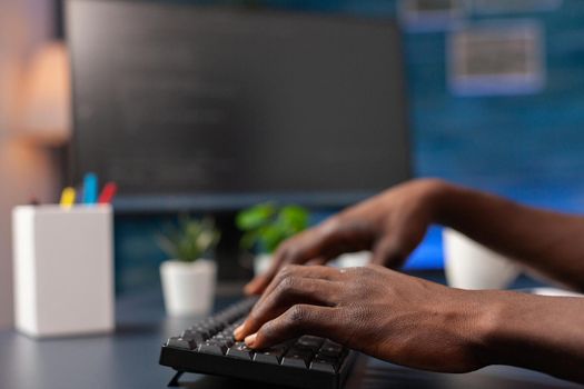 Closeup of african american employee hand programming binary code using network security system working remote from home. Programmer man browsing business server on computer. Security software