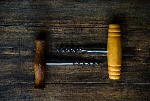 Vintage corkscrew on textured  rustic background