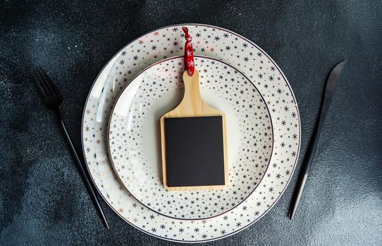 Holiday table setting for Christmas dinner on dark background