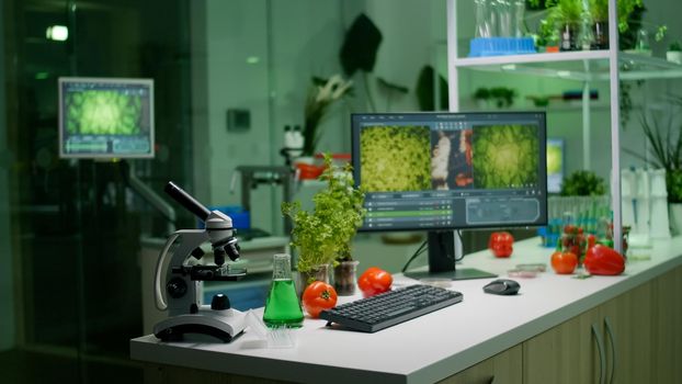 Empty microbiology laboratory with nobody in it prepared for genetic mutation analysis using hight tech tools. Interior of lab is equipped with microscope, test tubes ready for medical experiment