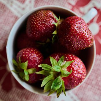ripe strawberries are collected from the garden in bowls close-up