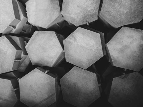 Abstract geometric background in the form of hexagons cut from a sheet of light gray cement slab by water on a CNC machine