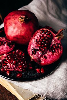 Ripe and juicy pomegranate fruit on metal plate