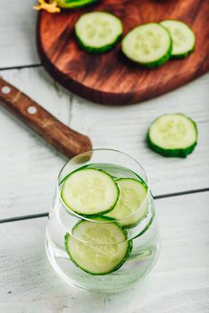 Water infused with sliced cucumber in a drinking glass