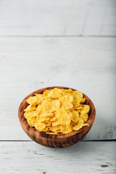 Corn flakes in a wooden rustic bowl