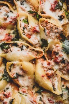 Baked jumbo shells pasta stuffed with ground beef, spinach and cheese