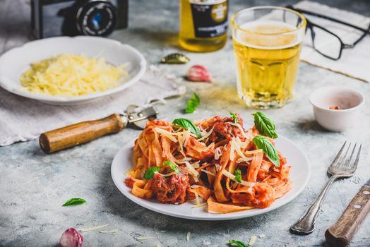 Pasta with mini meatballs, tomato sauce and parmesan cheese