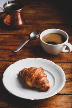 Croissant on White Plate and Cup of Turkish Coffee for Breakfast