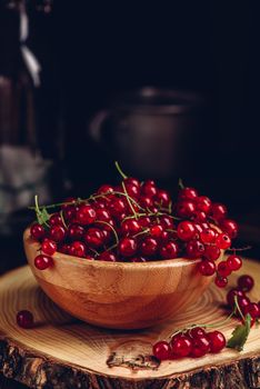 Fresh picked red currants in wooden bowl