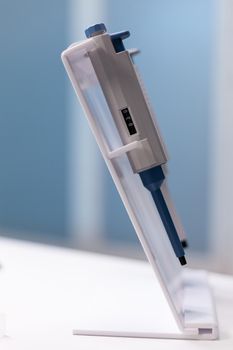 Close up of professional micro pipette on lab desk. Tool of chemical equipment in science laboratory used for research and mixing liquid, substance. Instrument for scientific test