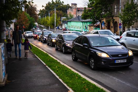 Cars in traffic at rush hour in downtown area of the city. Car pollution, traffic jam in the morning and evening in the capital city of Bucharest, Romania, 2021