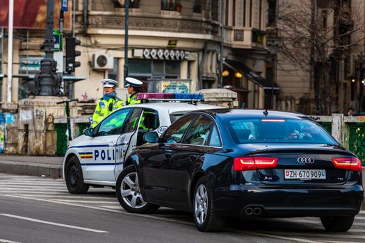 Cars in traffic at rush hour in downtown area of the city. Car pollution, traffic jam in the morning and evening in the capital city of Bucharest, Romania, 2021