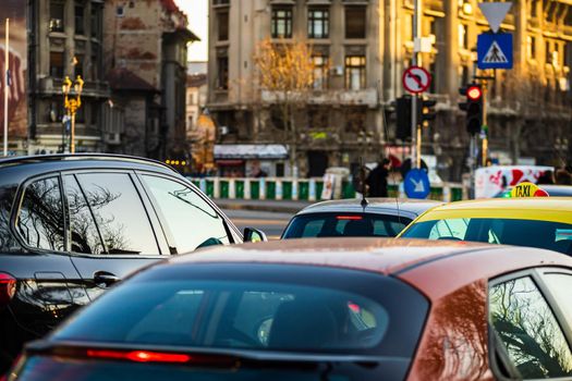 Cars in traffic at rush hour in downtown area of the city. Car pollution, traffic jam in the morning and evening in the capital city of Bucharest, Romania, 2021