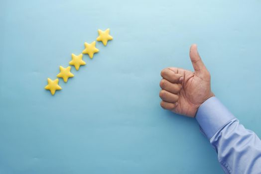 Customer review concept. Rating golden stars on blue background .