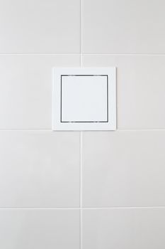 white plastic sunroof with water meters on white tiles on the bathroom wall.