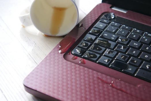 coffee spilling on laptop keyboard. close up .