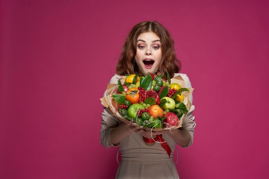 cheerful woman smile posing fresh fruits bouquet emotions Studio Model. High quality photo