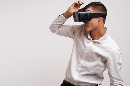 pretty man virtual reality glasses high-tech simulator technology studio. High quality photo