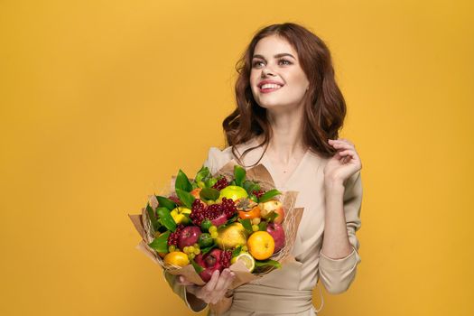 pretty woman beige coat fruit bouquet in hands present isolated background. High quality photo