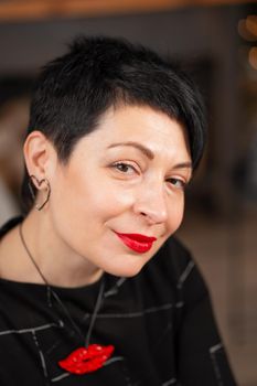Portrait of smiling short haircut brunette woman. With tired eyes.