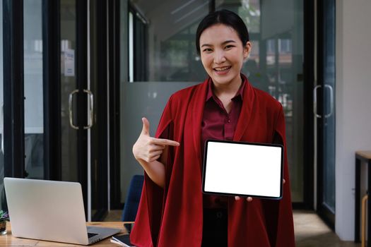 A Woman excited surprise and showing digital tablet white screen. Blank screen for your advertising