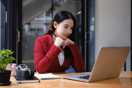 Businesswoman in having a video call on laptop while discussion with business partner during work from home