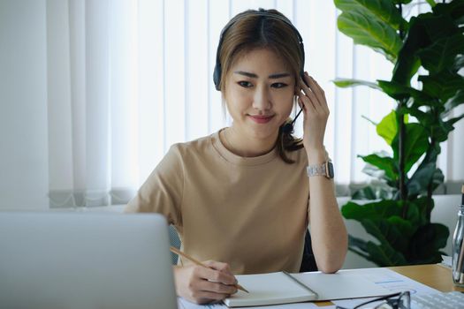 Businesswoman in having a video call on laptop while discussion with business partner during work from home. Support concept.