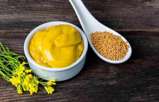 mustard sauce with its ingredients, turmeric, seeds and flowers