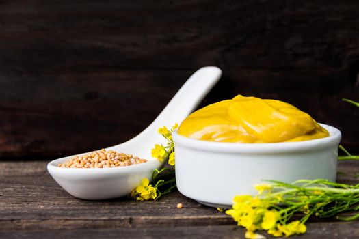 mustard sauce with its ingredients, turmeric, seeds and flowers