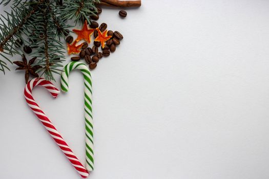 Caramel cane Christmas tree cone rowen branch on white background.new year