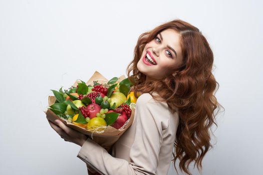 cheerful woman fun posing fruit bouquet vitamins Studio Model. High quality photo