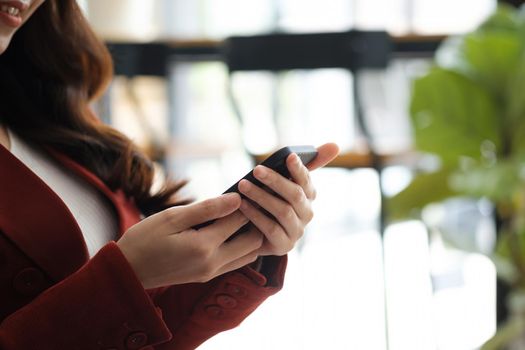 Close up woman using mobile phone in coffee cafe shop