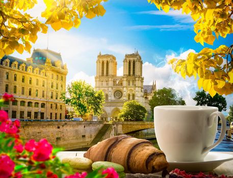 Breakfast with bakery and coffee on table near Notre Dame in Paris, France