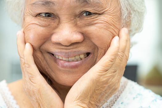 Asian senior or elderly old woman patient use denture and smile in nursing hospital ward, healthy strong medical concept