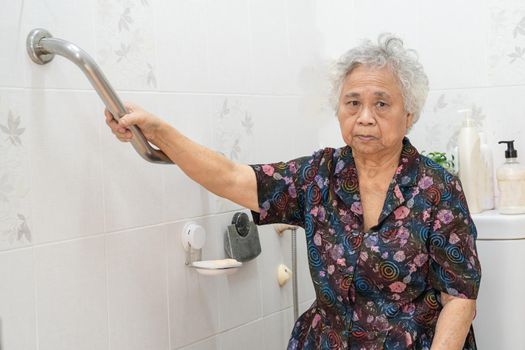 Asian senior or elderly old lady woman patient use slope walkway handle security with help support assistant in nursing hospital ward; healthy strong medical concept.