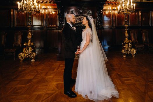 Elegant wedding couple in the interior of the old castle in the city of Nesvizh.