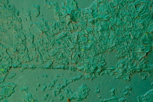 Old green paint on metal board. Texture for backdrop. Close up.