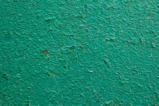 Old green paint on metal board. Texture for backdrop. Close up.