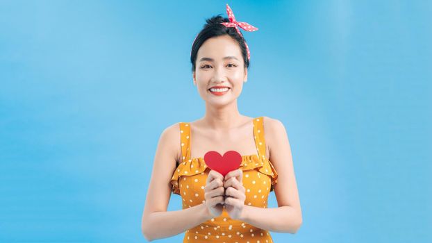 young smile woman hold red heart. valentine day concept. healthy lifestyle