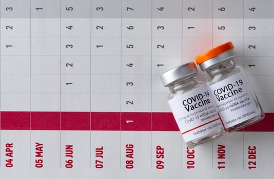 In the calendar, syringe with container of epidemic vaccine.