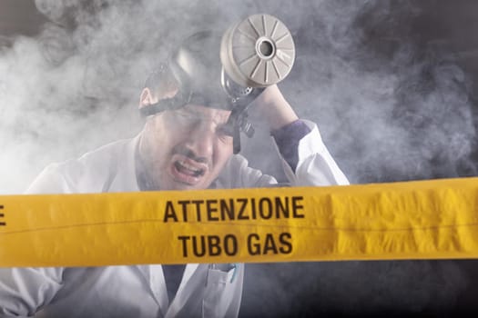 A medical engineer intoxicated by gas during the emergency. On the yellow tape the written notice "attention gas tube"