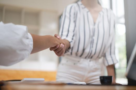 Business woman handshake for the new agreement after sign in agreement contract with work together