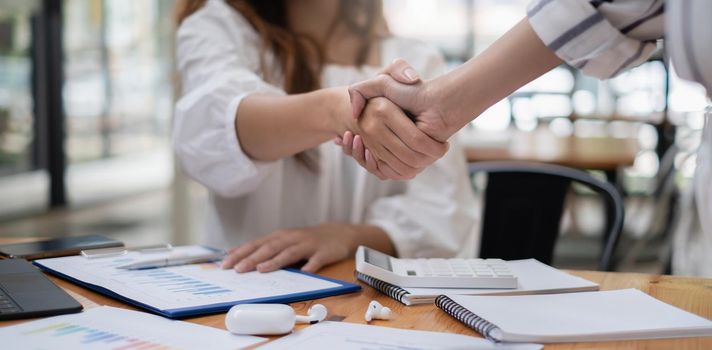 Business woman handshake for the new agreement after sign in agreement contract with work together