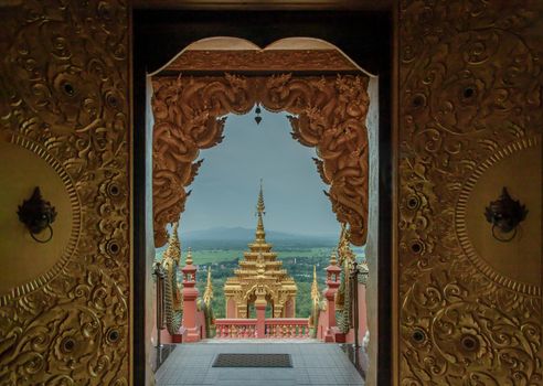 Lampang, Thailand - Sep 04, 2019 : Forest landscape under cloudy blue sky from gate of Wat Phra That Doi Phra Chan in Lampang. A temple on the top of a mountain the north of thailand. Selective focus.