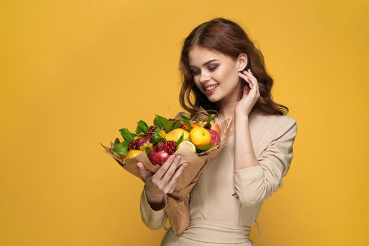 beautiful woman fashionable hairstyle bouquet of flowers decoration yellow background. High quality photo