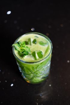 matcha cocktail or tea or latte with ice and mint isolated on black background. modern drinks. trendy cocktail.